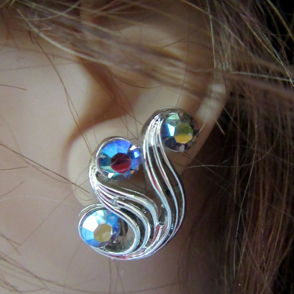 Vintage silver tone swirl clip on earrings with blue aurora borealis rhinestone